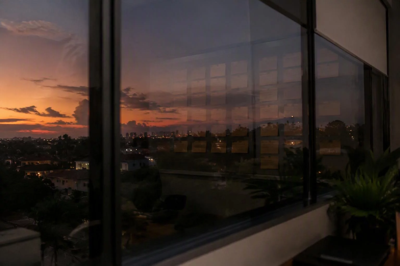 Janela do escritório com o quadro de contratos refletido no vidro